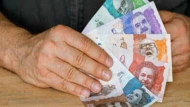 Colombia currency, a man holds a fan of money in his hand, Business and financial concept